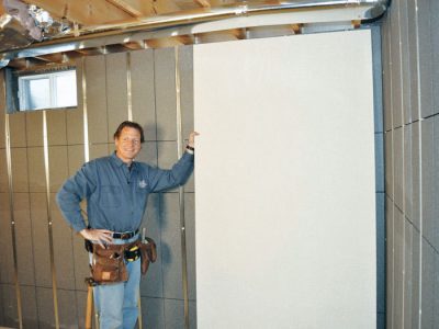 Installing wall panels on top of our basement wall insulation in Moorpark