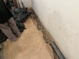 The process of removing the tile, digging and prepping it for the water guard.