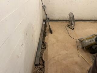 The process of removing the tile, digging and prepping it for the water guard.