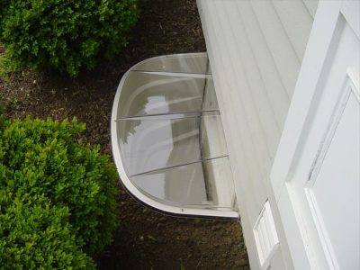 Covered plastic basement window well system