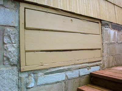 an old-fashioned crawl space door in about to be replaced